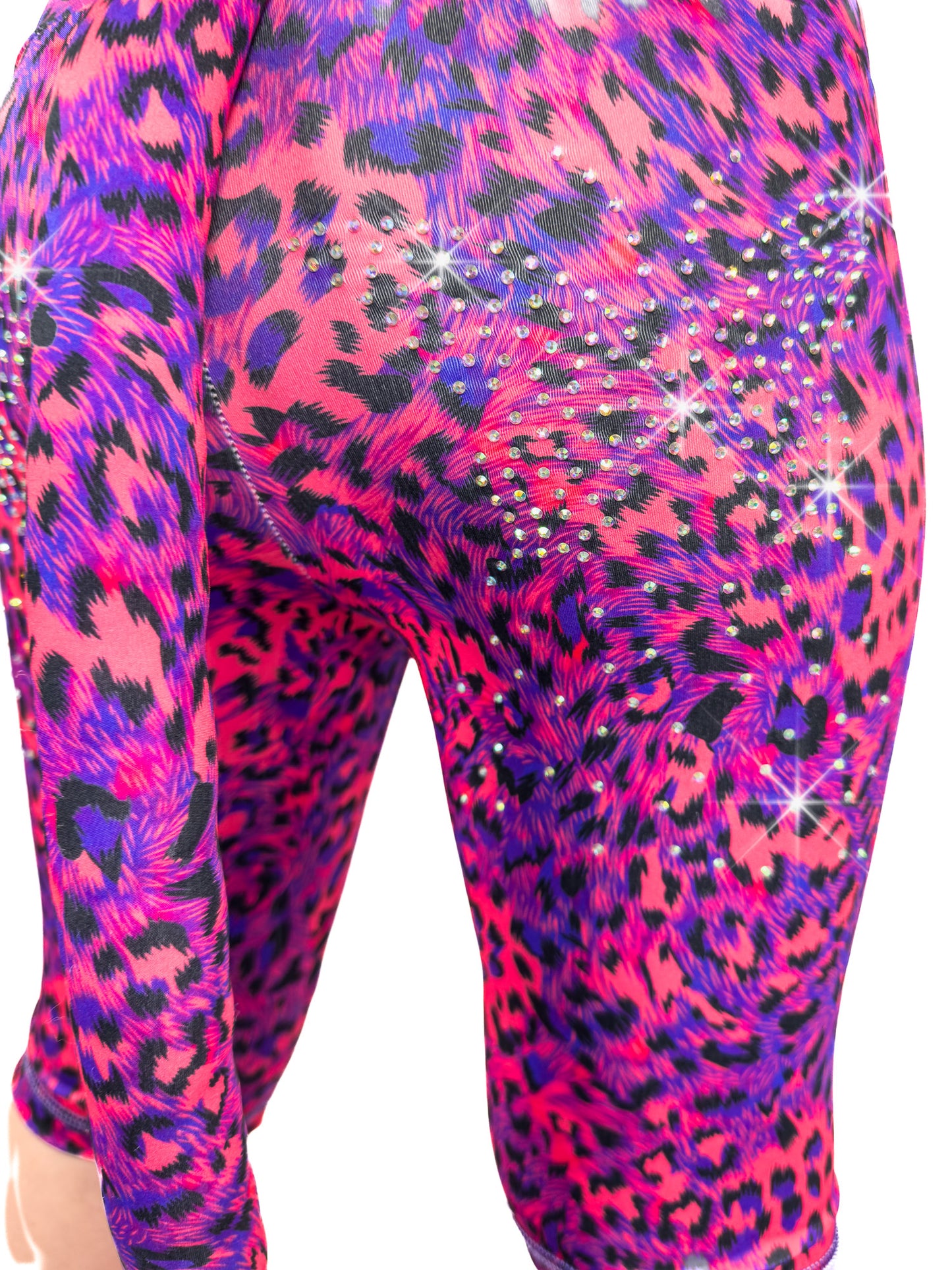 Back view of blue and red leopard shorts, leggings with sparkly rhinestones and a tail.