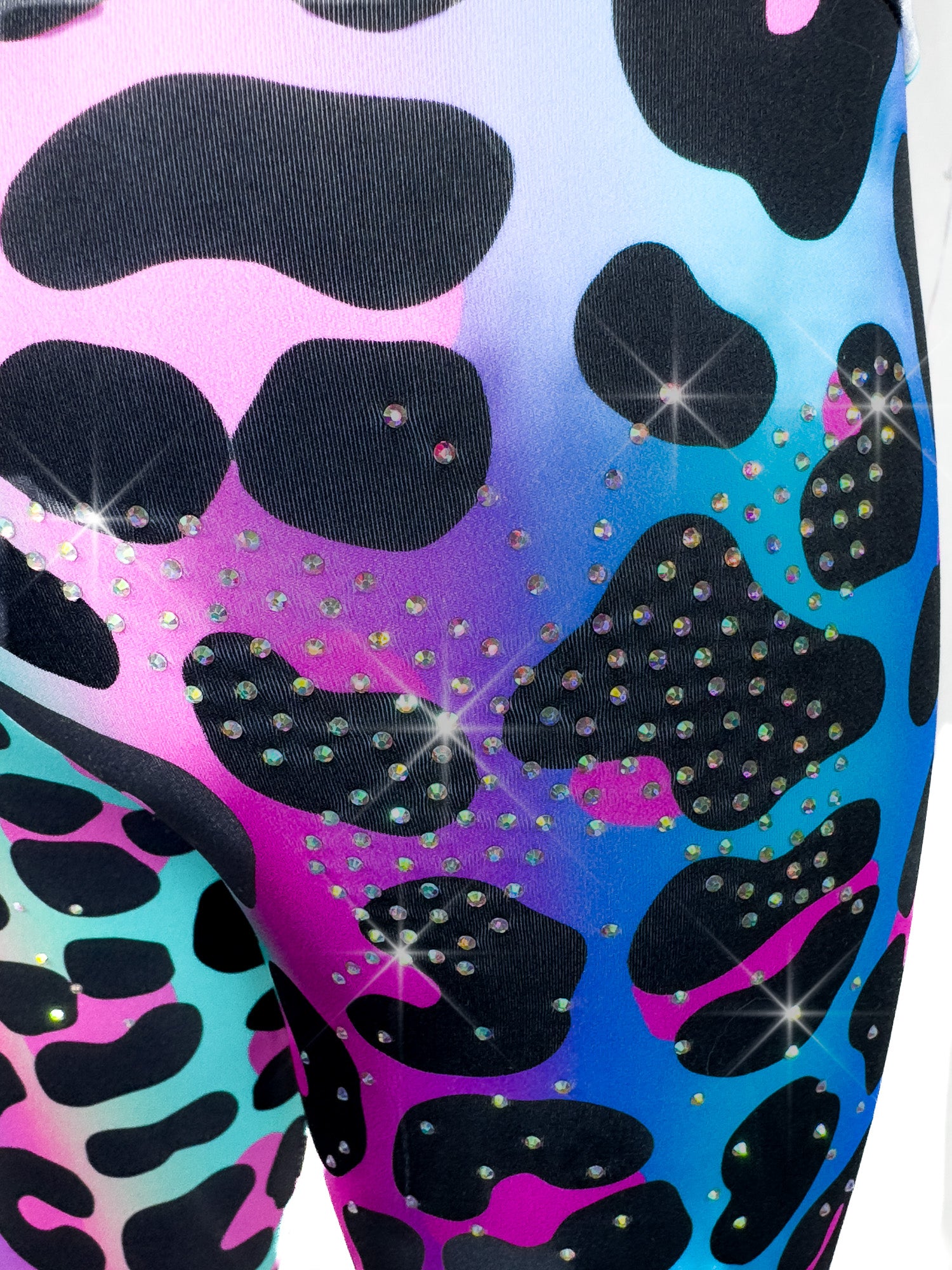 Close up back view of Tailys sparkly rhinestone shorts for girls rainbow leopard leggings tail pants.