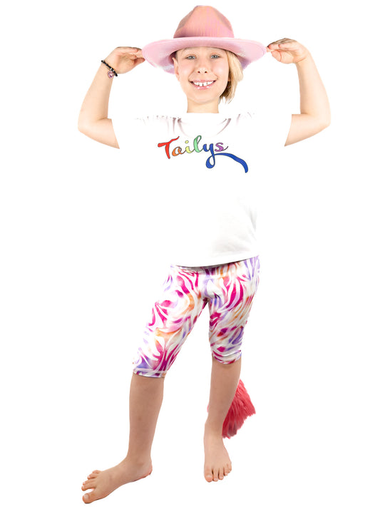 Girl with hat wearing Tailys, girls shorts, pastel zebra leopard print leggings tail pants.