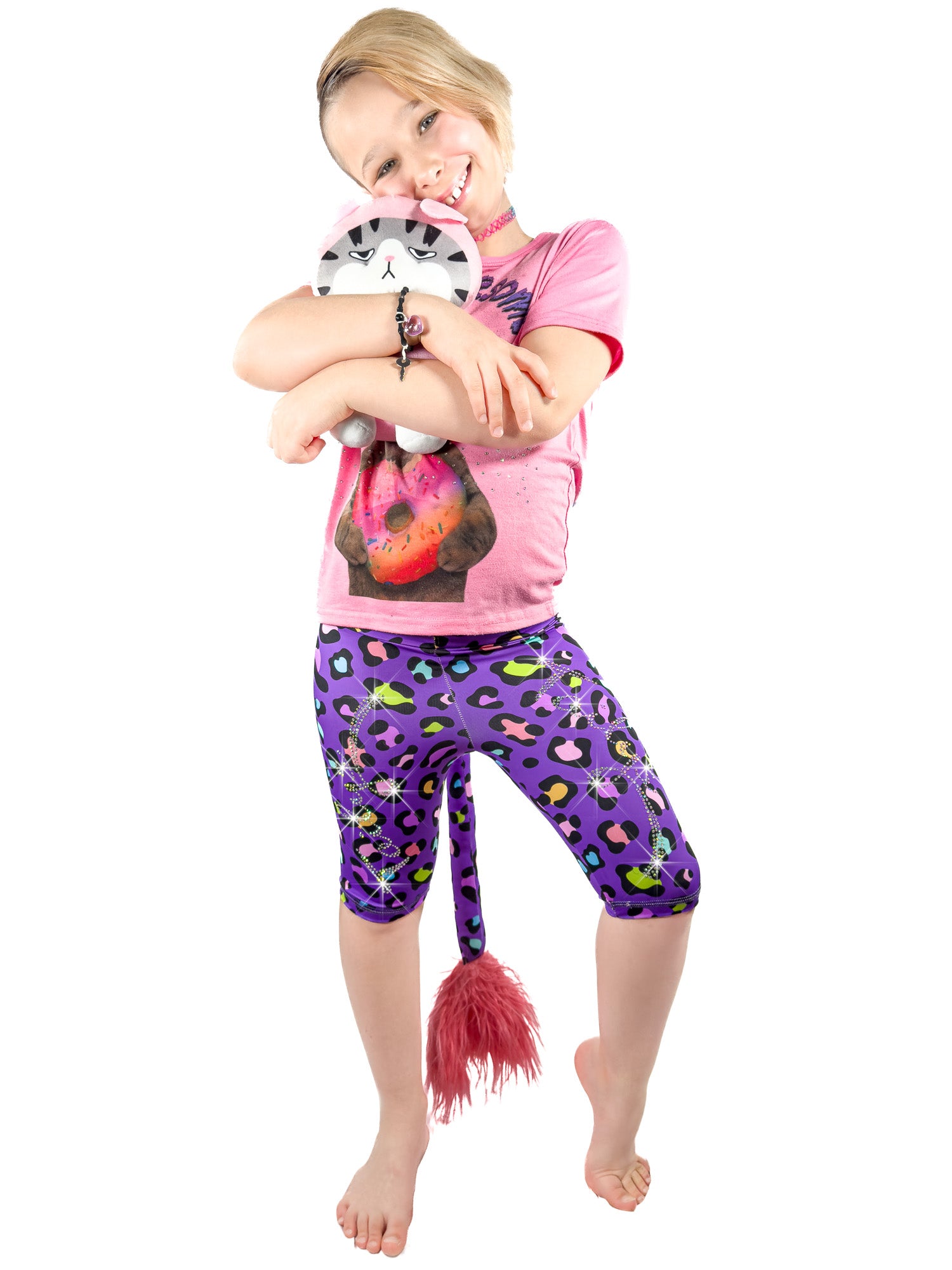 Girl with toy wearing Tailys sparkly rhinestone shorts for girls purple leopard print leggings tail pants.