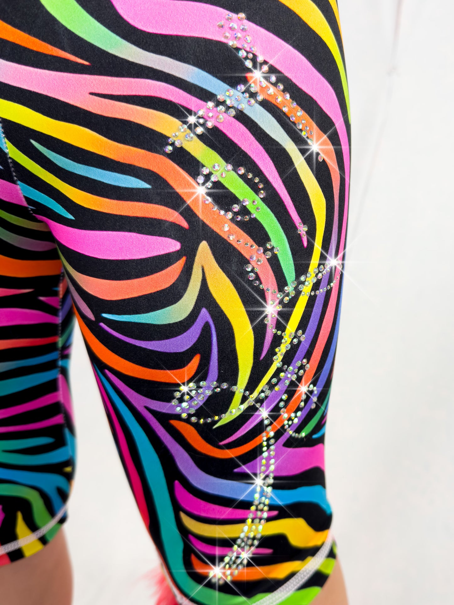 Close up front view of rhinestone Tailys kids shorts for girls rainbow zebra leggings tail pants.