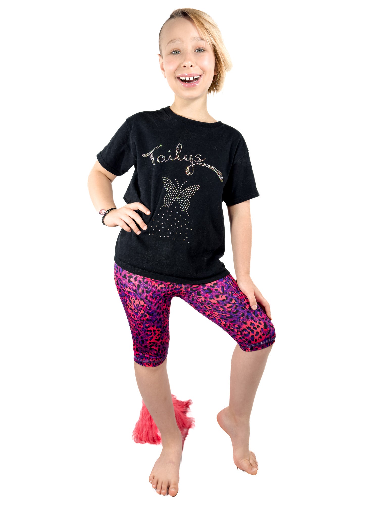 Girl wearing Tailys, girls shorts, blue red leopard print leggings tail pants.