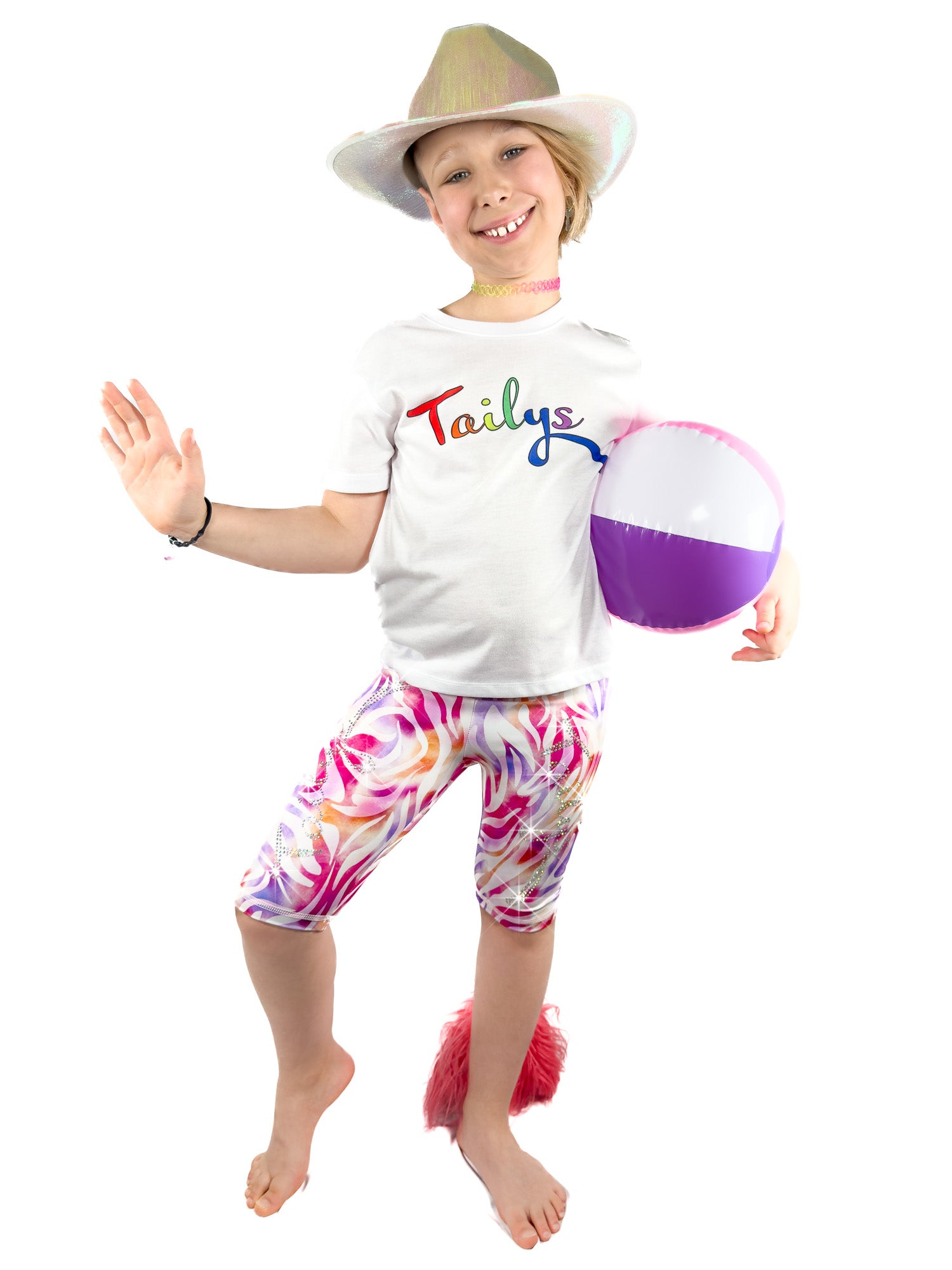 Cute girl, with ball, wearing sparkly rhinestone pastel zebra shorts leggings with a tail by Tailys.