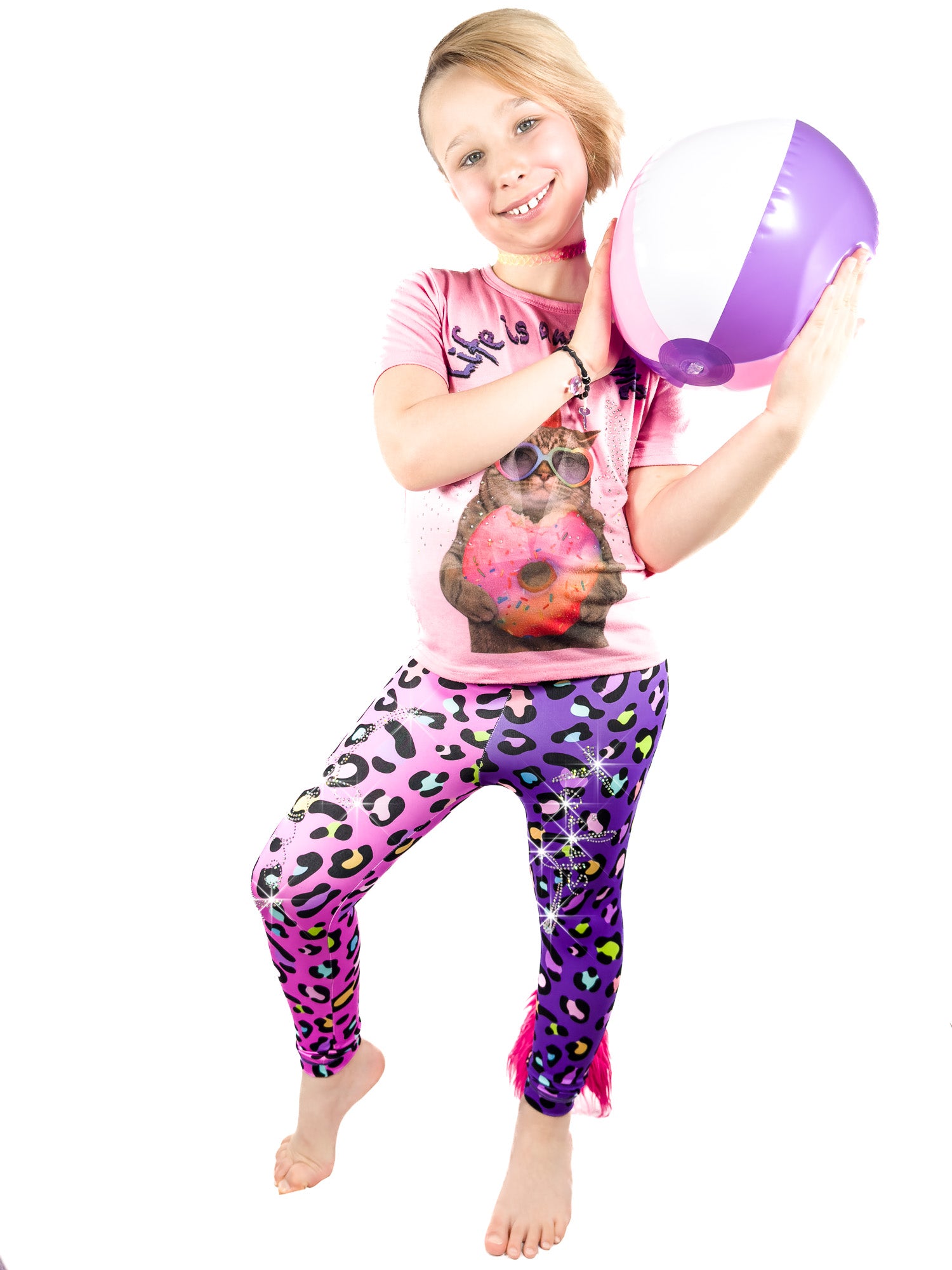 Girl with ball wearing Tailys two tone leggings tail pants, pink and purple Cheetah with rhinestones.
