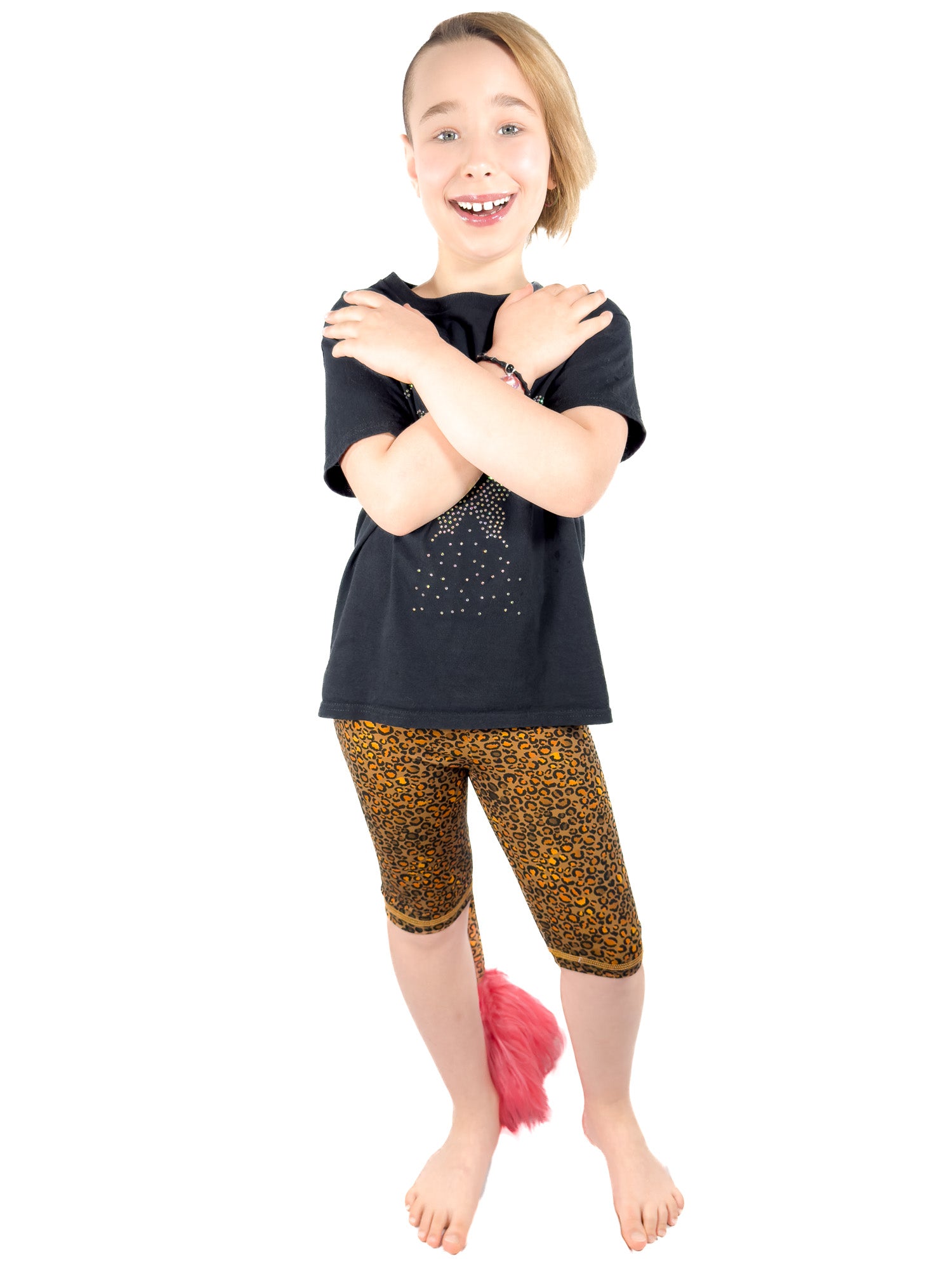 Girl wearing Tailys shorts for girls, brown cheetah print leggings tail pants.