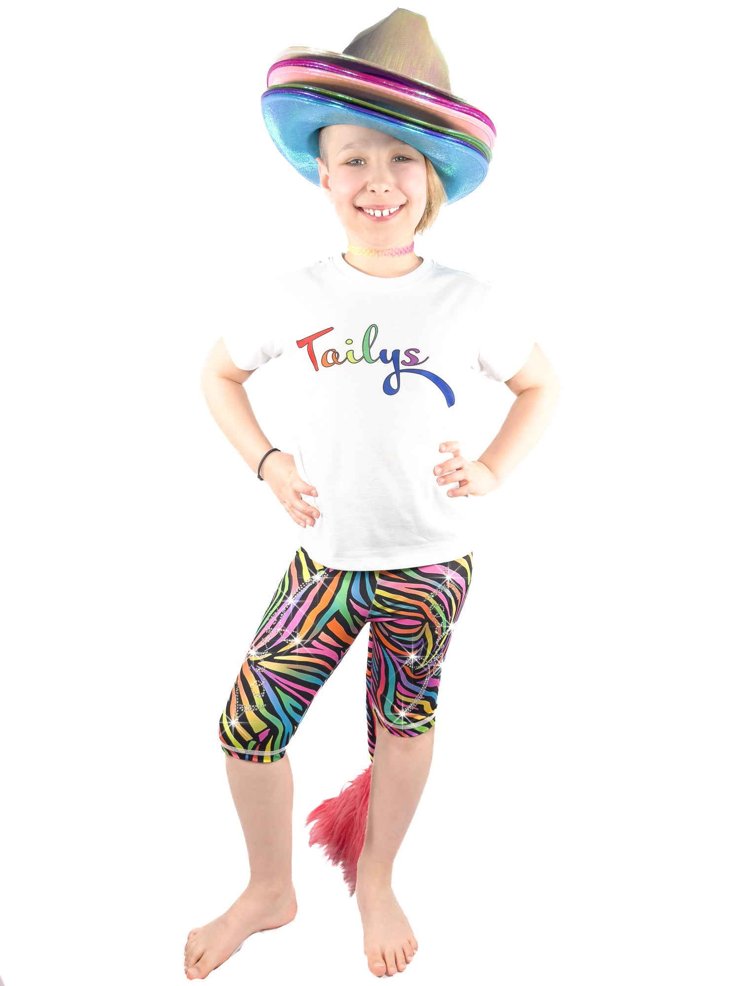 Girl with many hats wearing rhinestone Tailys kids shorts for girls rainbow zebra leggings tail pants.