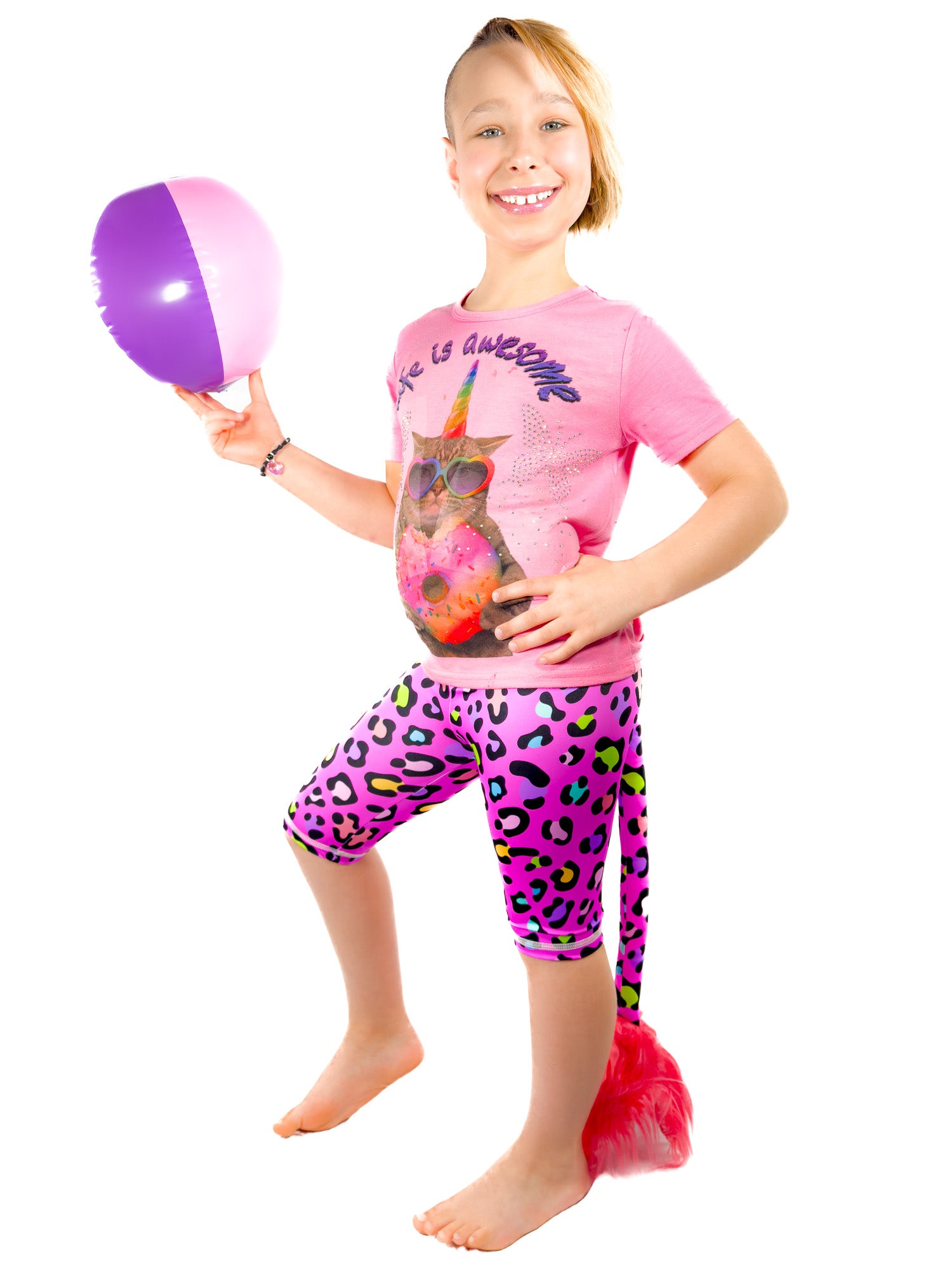 Girl with ball wearing Tailys cute shorts for girls leopard print pink leggings tail pants.