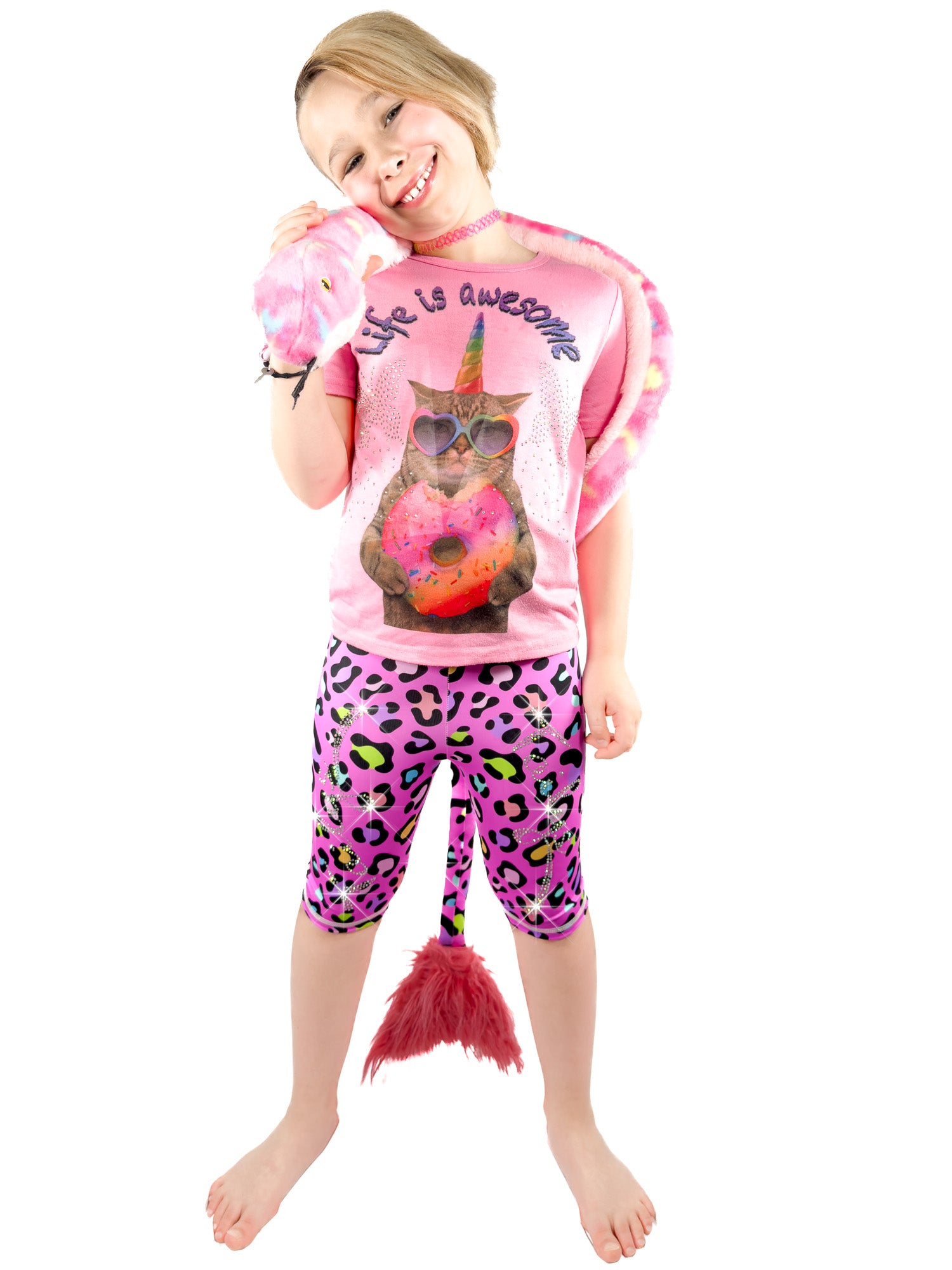 A girl with toy wearing Tailys sparkly rhinestone shorts for girls leopard print pink leggings tail pants.